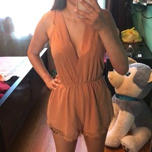 Peach romper with lace trimmings